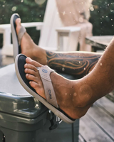 The Olukai Mens Pili Flip Flops in Ash & Mood Indigo