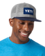The Yeti Mens Velcro Badge Flat Brim Mesh Cap in Grey & Navy