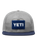 The Yeti Mens Velcro Badge Flat Brim Mesh Cap in Grey & Navy