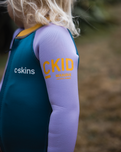 The C-Skins Girls NuWave C-Kid Baby Front Zip Wetsuit in Steel Blue & Lilac