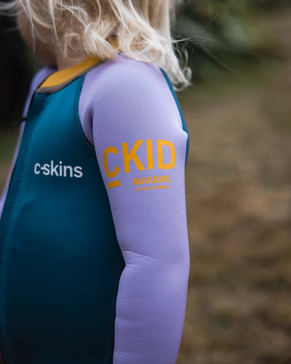 The C-Skins Girls NuWave C-Kid Baby Front Zip Wetsuit in Steel Blue & Lilac