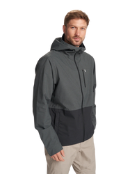 Man wearing a gray jacket with a hood on a white background